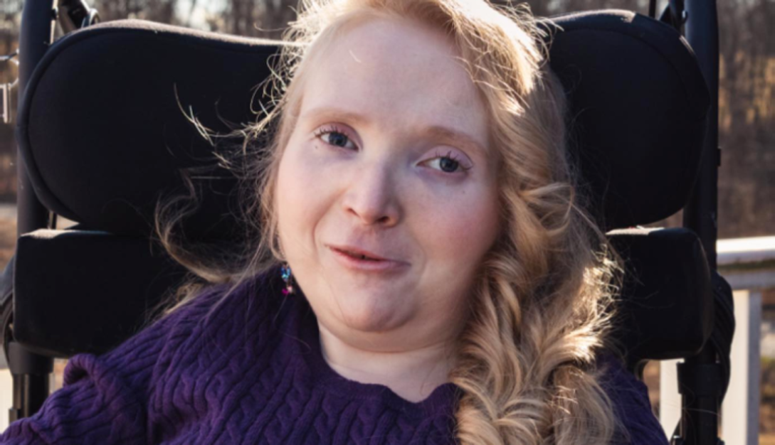 Emily softly smiling at camera.